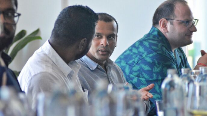 a group of men sitting next to each other at a table