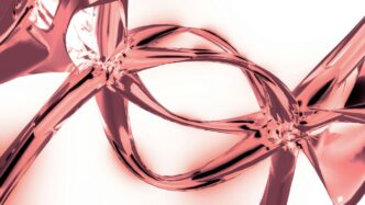 A close up of a pink ribbon on a white background