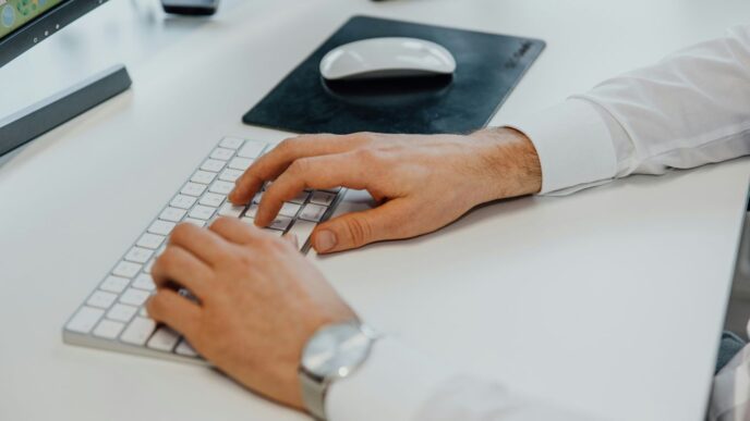 a man is typing on a computer keyboard
