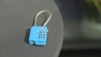 A small blue combination lock rests on a surface.