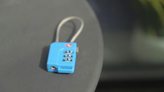 A small blue combination lock rests on a surface.