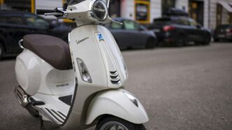 a white scooter parked on the side of the road