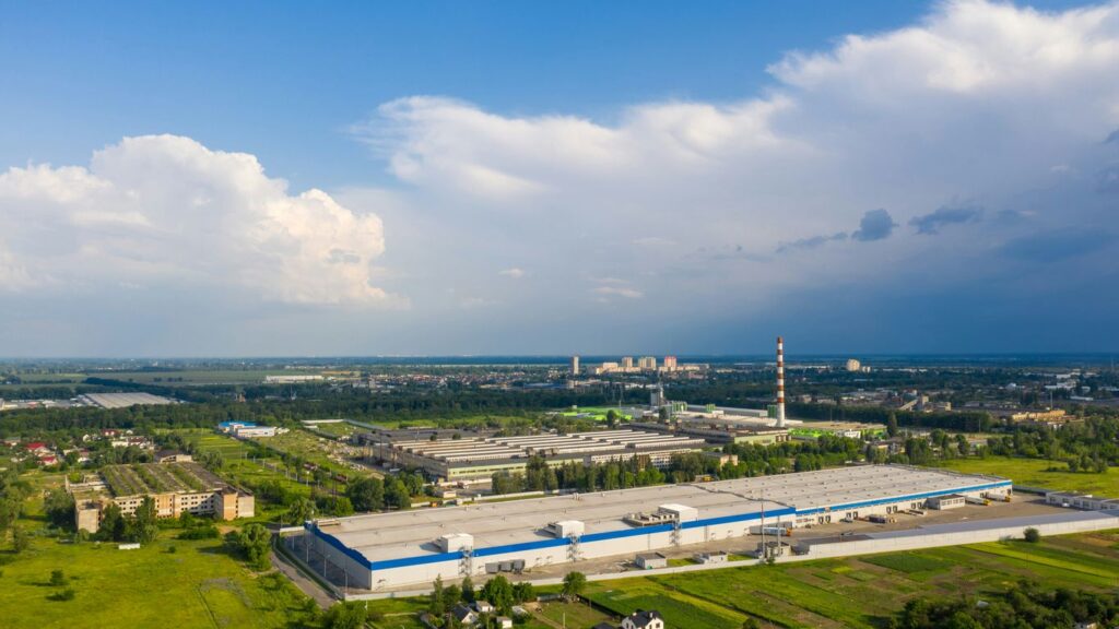 white and blue building near green grass field under blue sky during daytime