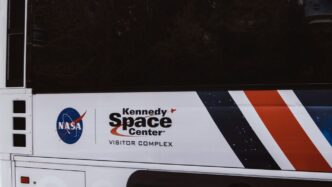 white and orange car showing license plate