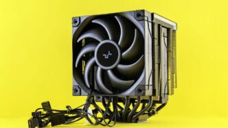 Computer cpu cooler with fan on yellow background