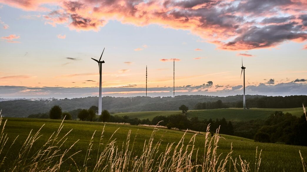 green grass field under cloudy sky during daytime