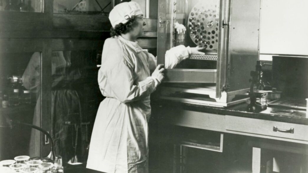 a black and white photo of a woman in a lab