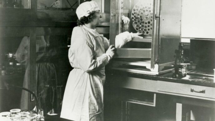 a black and white photo of a woman in a lab