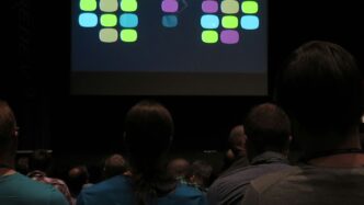 people near projector canvas