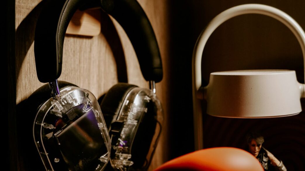 A pair of headphones sitting on top of a wooden shelf