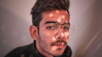 man in black crew neck shirt wearing silver framed eyeglasses