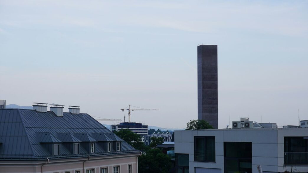Tall modern building against a cloudy sky.