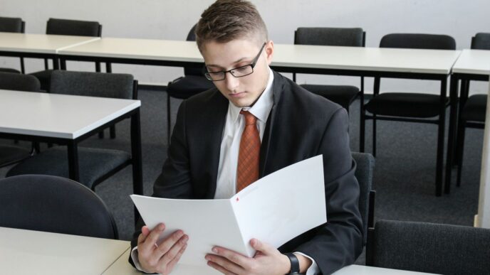 man holding folder in empty room