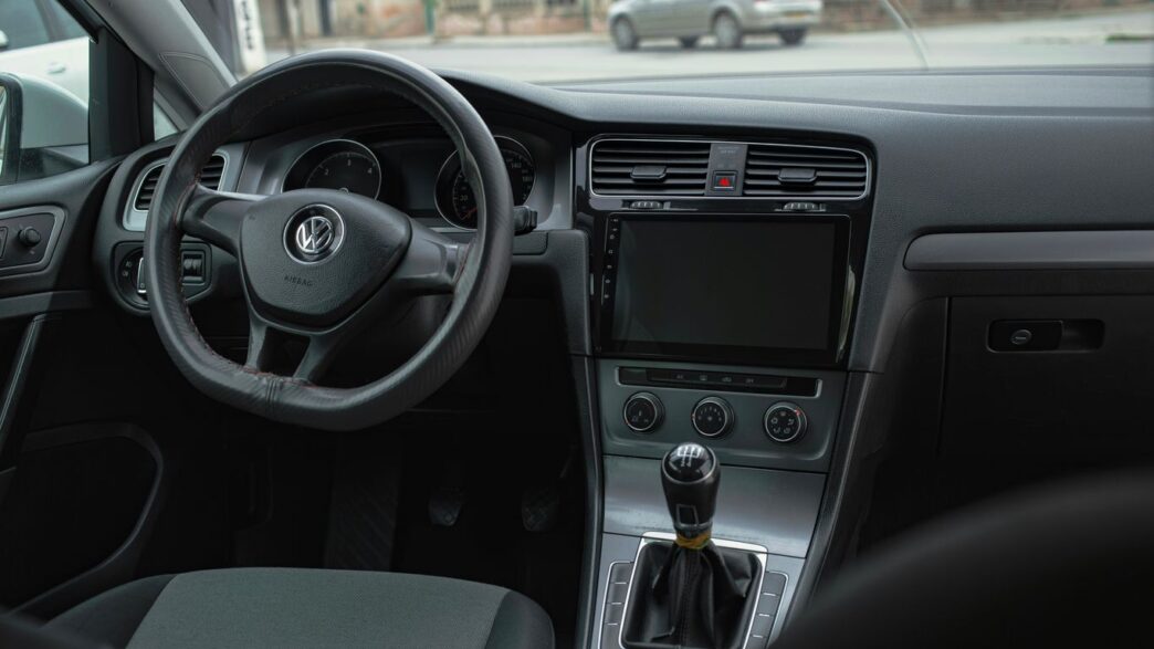 the interior of a car with a steering wheel and dashboard
