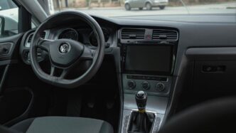 the interior of a car with a steering wheel and dashboard