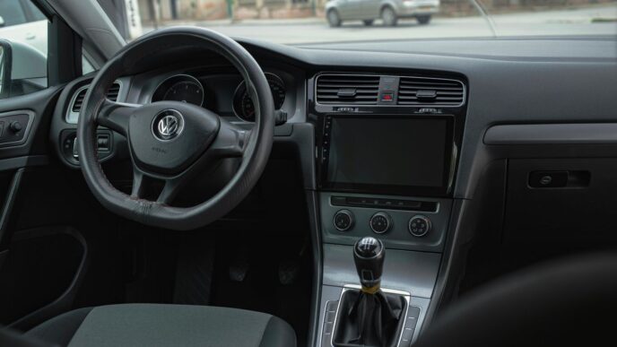 the interior of a car with a steering wheel and dashboard