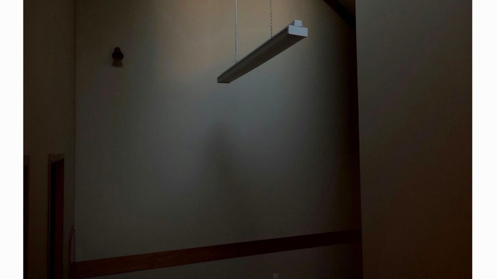 a room with a light hanging from the ceiling