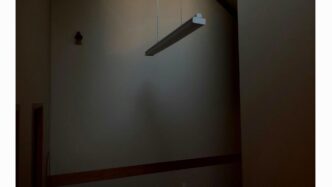 a room with a light hanging from the ceiling