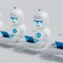 a group of white robots sitting on top of laptops