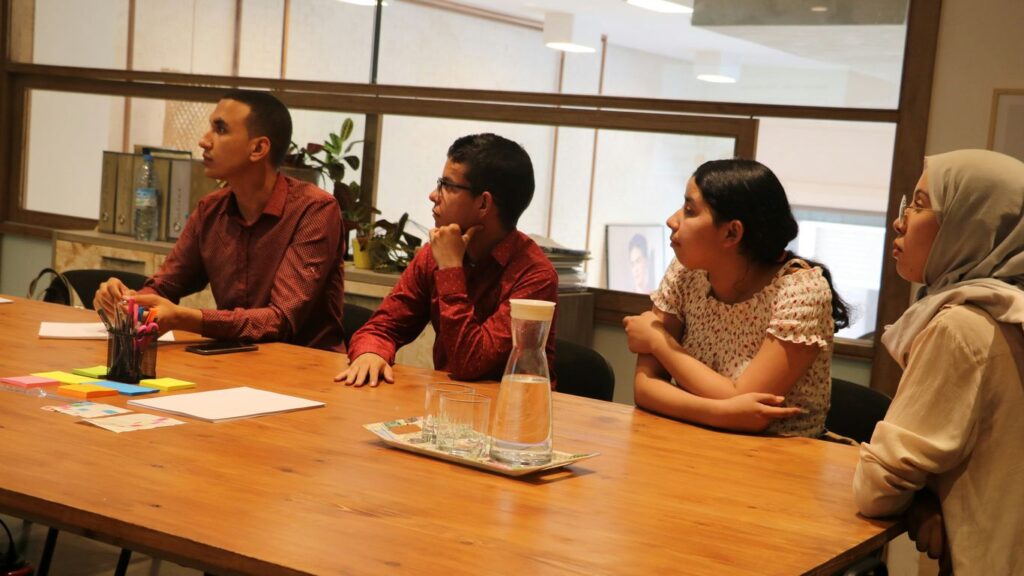 two women and men sitting at table