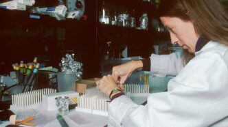 a woman in a lab coat is doing something