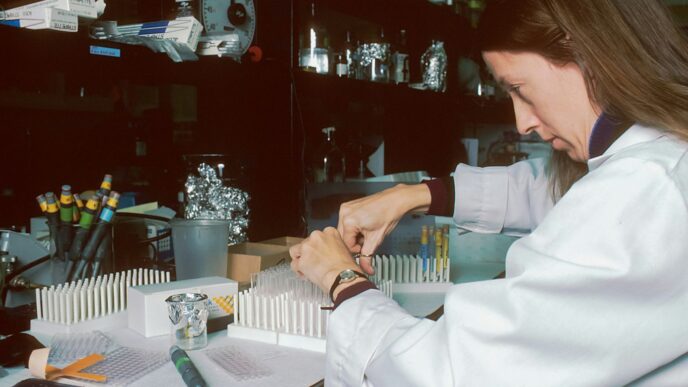a woman in a lab coat is doing something