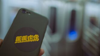 a person holding a cell phone in their hand