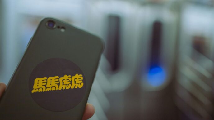 a person holding a cell phone in their hand