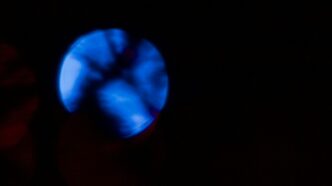 A glowing blue orb against a dark background.