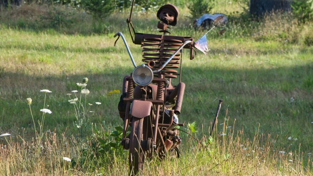 A sculpture of a man holding a flag on top of a motorcycle