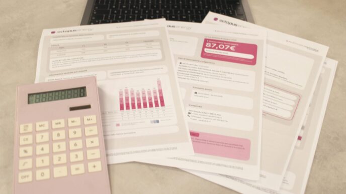 Bills, calculator, and a laptop: financial tasks underway.