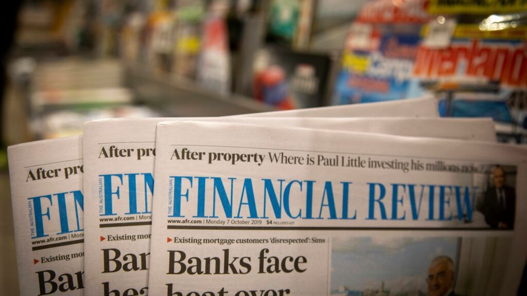 newspapers are stacked on top of each other