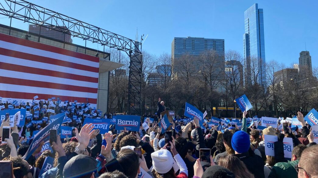 people gathering near us flag during daytime