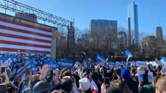 people gathering near us flag during daytime