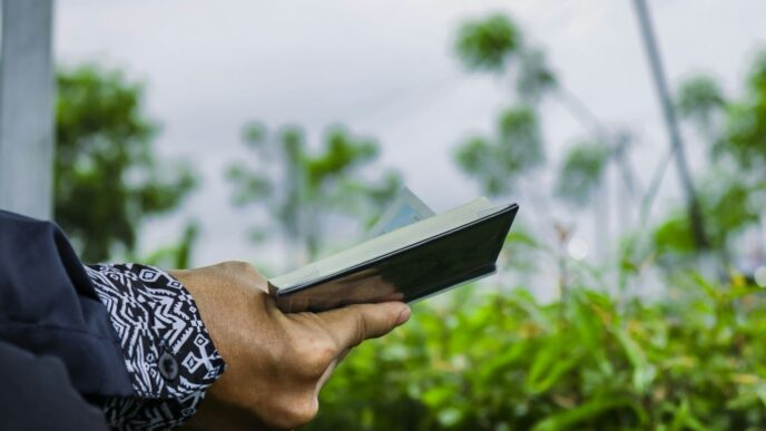 a person holding a book in their hand