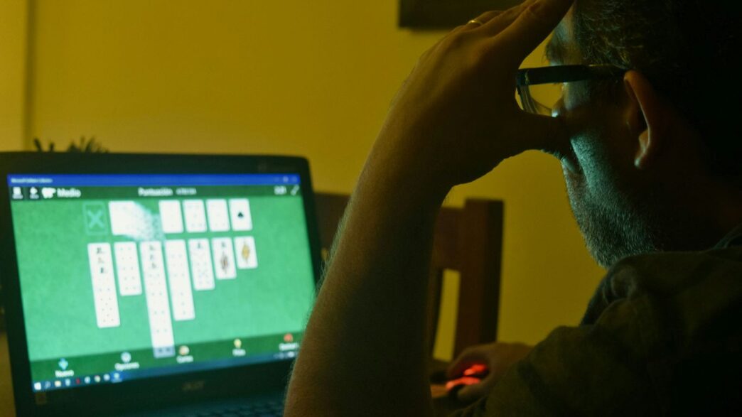 a man sitting in front of a laptop computer