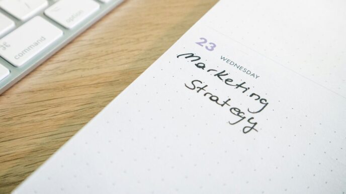 a notepad with the words marketing strategy written on it