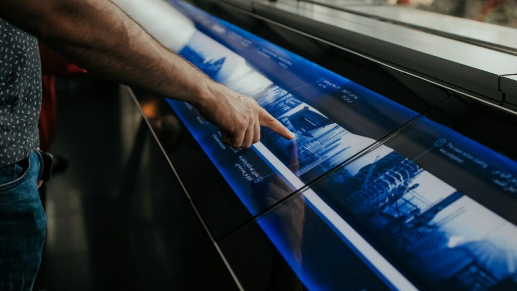 a man is pointing at a large poster
