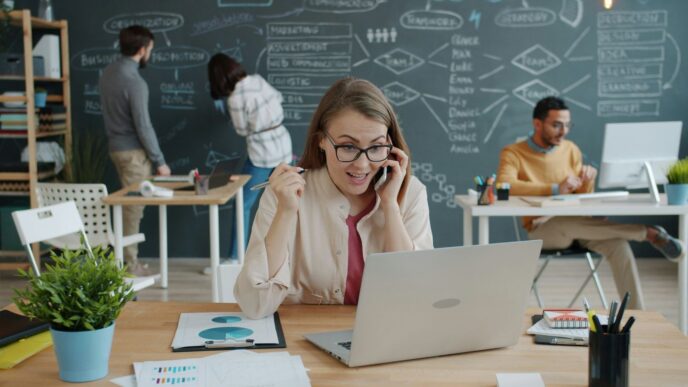 Woman celebrating success while on a business call.