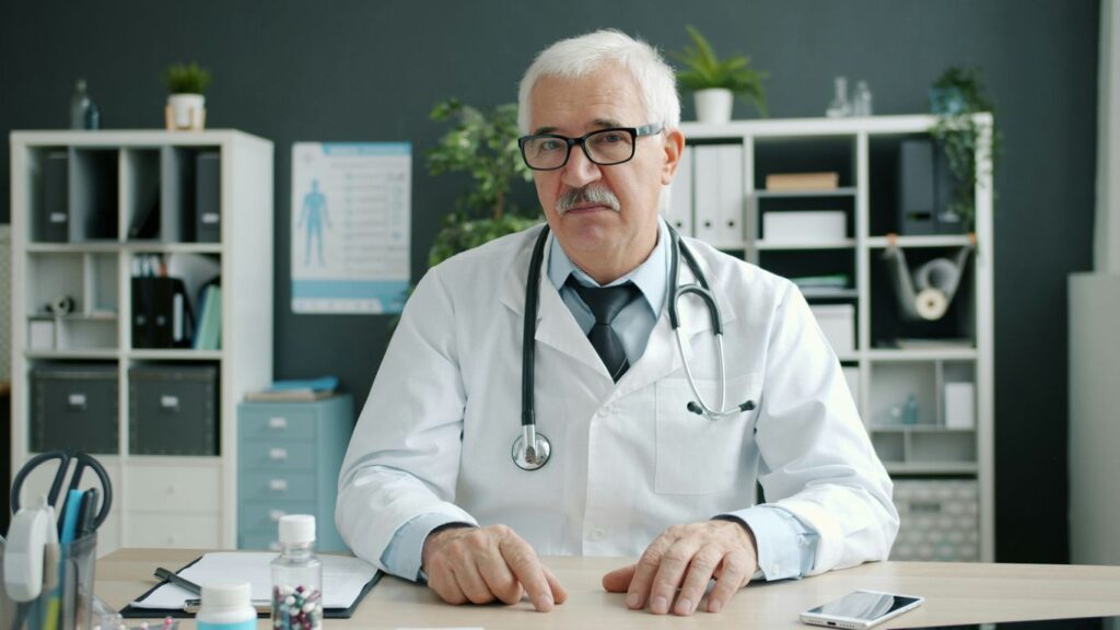 Doctor wearing a stethoscope at his desk
