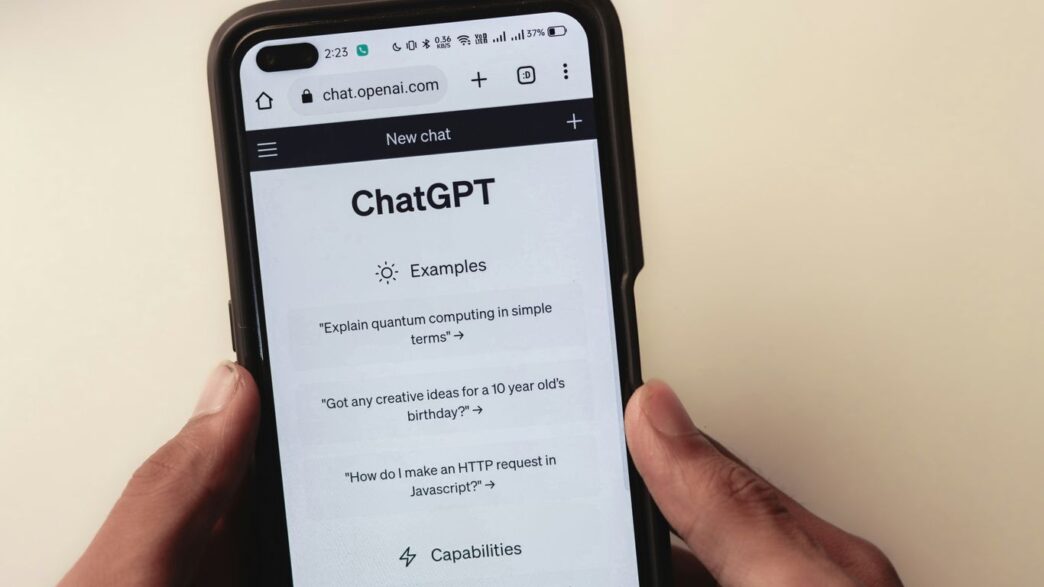 a person holding a cell phone with a chat app on the screen