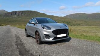 black bmw m 3 on dirt road during daytime