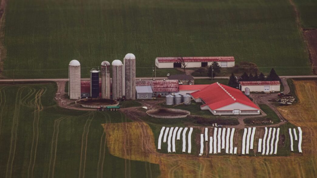 an aerial view of a farm with a red roof