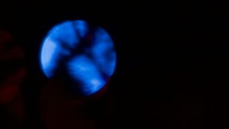 A glowing blue orb against a dark background.
