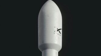 a close up of a white rocket on a black background
