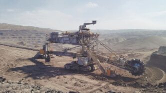 gray heavy equipment on vast land during daytime
