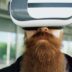 Man with long beard wearing virtual reality headset