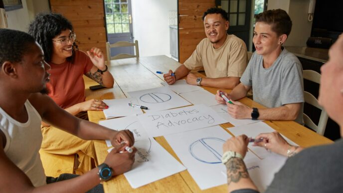a group of people sitting around a wooden table