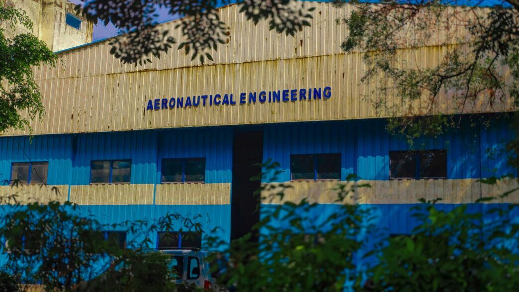 a blue and yellow building with trees in front of it