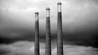 grayscale photo of three different height lighthouses